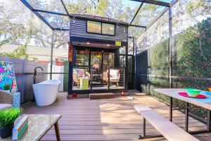 a tiny house with a glass roof on a deck at FunTropicalTinyHomeGolfCartLake in Orlando