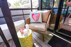 a chair with a pillow on a table on a balcony at FunTropicalTinyHomeGolfCartLake in Orlando