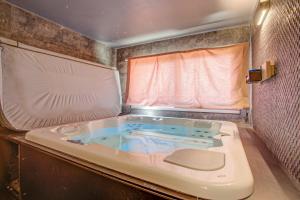 a bath tub in an rv with a window at Chalet Niyama - Avec jacuzzi et station à pied in Font-Romeu +18 photos