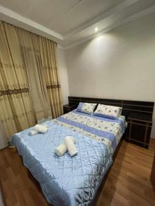 a bedroom with a bed with two towels on it at Paata in Kutaisi