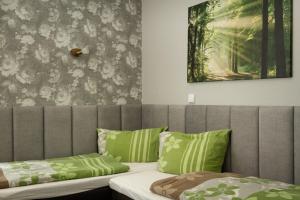 a bedroom with two beds with green pillows at Ferienwohnung Prinke in Niedertrebra