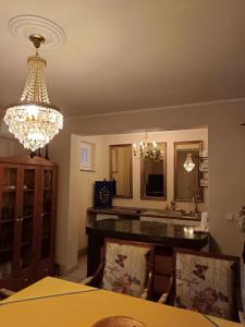 a dining room with a table and a chandelier at Stara Ruža in Gračanica