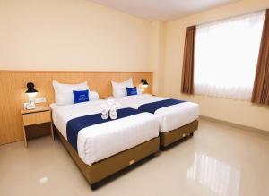 Ένα ή περισσότερα κρεβάτια σε δωμάτιο στο Hotel Dafam Rio