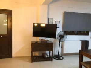 a room with a television on a table with a fan at DIAMOND Stone Wooden Guest House in Khandria