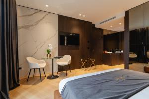 a bedroom with a bed and a table and chairs at Green Park Penthouse Suite & Pool - Heated Pool - in Bari