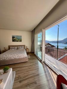 a bedroom with a bed and a large window at Villa Giulietta lake view Jacuzzi Spa 108 in Blevio