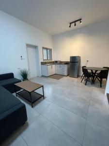 a living room with a couch and a table at בית בעמק בעיצוב מודרני וחמים in Bet Sheʼan