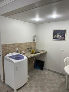 a kitchen with a sink and a dishwasher at Casa 3Jotas in Garopaba +47 photos