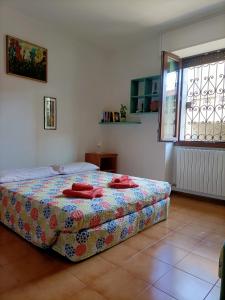 a bedroom with a bed with red towels on it at La Casa di Vicky in Maslianico +23 photos