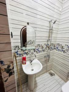 a bathroom with a sink and a mirror at ANA-KA Guest house in Aswan +75 photos