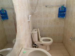 a bathroom with a toilet and a shower and a sink at No 36 Surf Paradise Apartment in Matara
