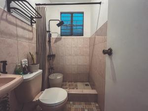 a bathroom with a toilet and a sink at Full AC 4BR & LivingRm entire vacation home at Vigan City in Vigan +51 photos