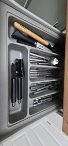 a drawer filled with utensils in a kitchen at Swindon Dream in Liverpool