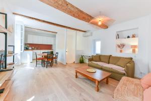 salon z kanapą i stołem w obiekcie L'EMERAUDE duplex confortable au cœur de Cannes, proche plage du Midi et Palais w Cannes
