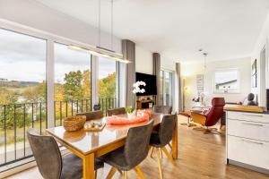 a kitchen and dining room with a table and chairs at Ferienhaus Catharina in Diemelsee