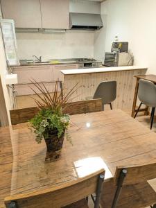 a wooden table with a potted plant on top of it at お宿みとしる in Mito