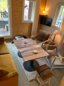 a living room with a wooden table and chairs at Isola 2000 appartement dans Chalet 4 ou 6 personnes grande terrasse in Isola 2000