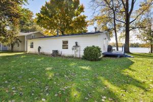 a white house with a yard with a grass yard at Lakefront Home with Dock Firepit & Private Deck in Grand Junction