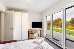 a bedroom with a bed and a desk with a computer at Ferienhaus Catharina in Diemelsee