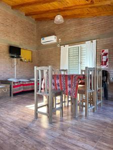 a dining room table and chairs with a tablecloth on it at Casa Caviahue in Villa Carlos Paz