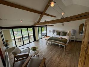 a bedroom with a bed and a living room at The Old Cattle Barn in Silverstone