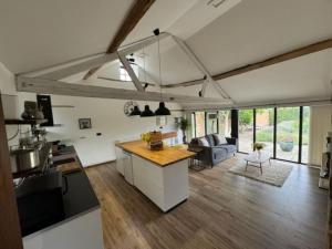 an open kitchen and living room with a counter top at The Old Cattle Barn in Silverstone