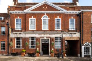 a red brick building with a sign that reads charters farms at Teller's Arms in Farnham