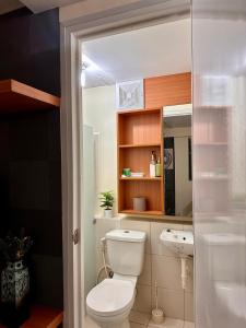 a bathroom with a toilet and a sink at VR Homes Ortigas - 2BR Condo with Free WiFi in Manila