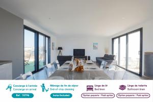 a living room with a table and chairs and windows at Maison tout confort 4 adultes et 4 enfants in Le Bois-Plage-en-Ré