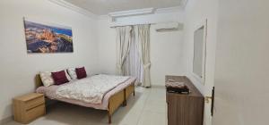 a small bedroom with a bed and a window at Sea View apartment on Promenade S1 in Sliema