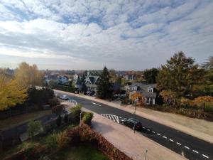 a city street with houses and cars on the road at Piastów Luna Room in Piastów