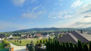 a view of a village with houses and trees at Skandynawski domek in Tylicz