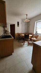 a kitchen and living room with a table and a couch at Oleander in Güntersberge