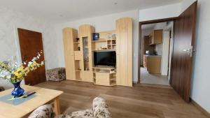a living room with a table and a television at Oleander in Güntersberge