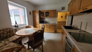 a kitchen with a table and a couch and a table at Oleander in Güntersberge