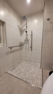 a bathroom with a shower with a tile floor at Oleander in Güntersberge +5 photos