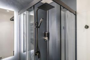 a shower with a glass door in a bathroom at Modern & stylish 3BR in the heart of Malaga by REMS in Málaga +31 photos