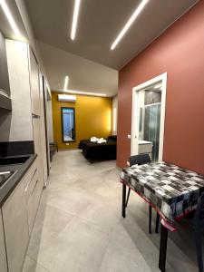 a kitchen and living room with a table and a couch at Residence Oasi Di Monza in Monza