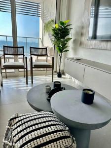 a living room with a table and chairs and a large window at Elegant 5-Bedroom Apartment in Exclusive Playa Escondida Pet Friendly in María Chiquita