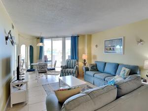 a living room with a couch and a table at Poolside Paradise in North Topsail Beach