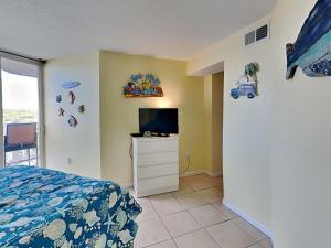 a bedroom with a bed and a flat screen tv at Poolside Paradise in North Topsail Beach +15 photos
