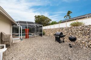a backyard with a glass house and a grill at 1969 Marco Island in Marco Island