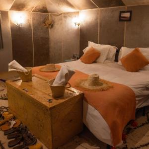 A bed or beds in a room at Luxury Merzouga Desert Camp
