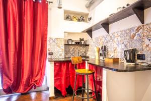 a kitchen with a red curtain and a counter at The Magic Hole in Rome