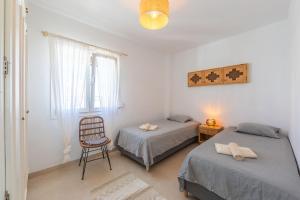 Łóżko lub łóżka w pokoju w obiekcie Los Lances Beach Apartments
