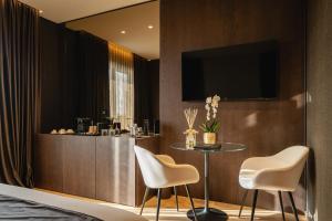 a hotel room with a table and two chairs at Green Park Penthouse Suite & Pool - Heated Pool - in Bari