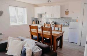 a kitchen with a table and chairs and a couch at Glasgow City - 1 Bedroom Apartment in Glasgow