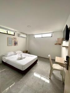 Postel nebo postele na pokoji v ubytování Hotel La Estrella de David Cartagena