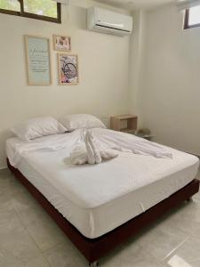 Postel nebo postele na pokoji v ubytování Hotel La Estrella de David Cartagena