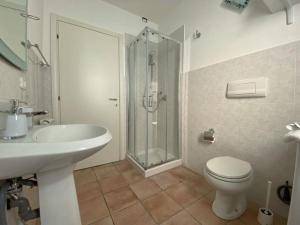 a bathroom with a toilet and a sink and a shower at Appartamento Bellavista in Terricciola +16 photos